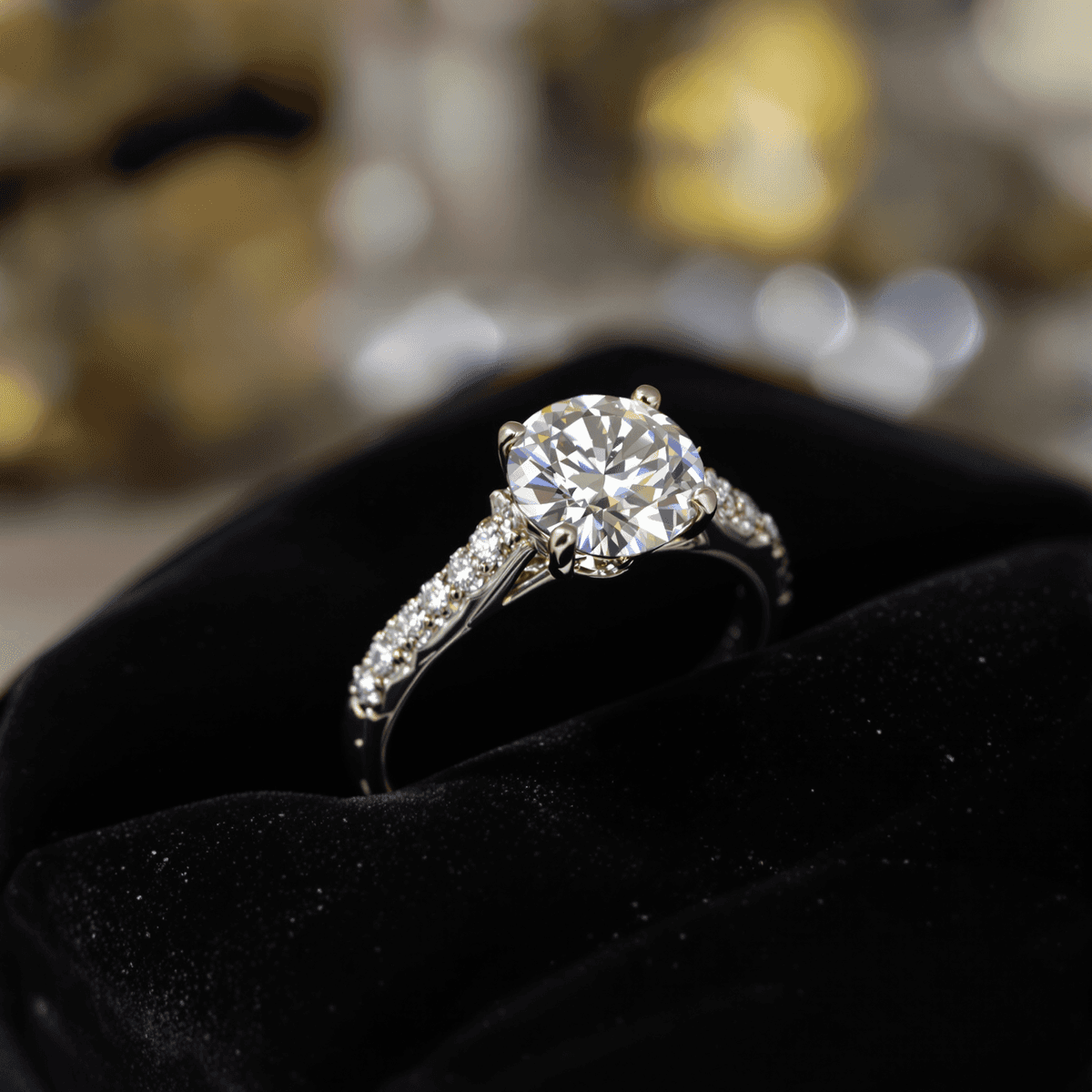 Close-up of a sparkling lab-grown diamond engagement ring on black velvet, softly lit to highlight the diamond's brilliance and clarity.