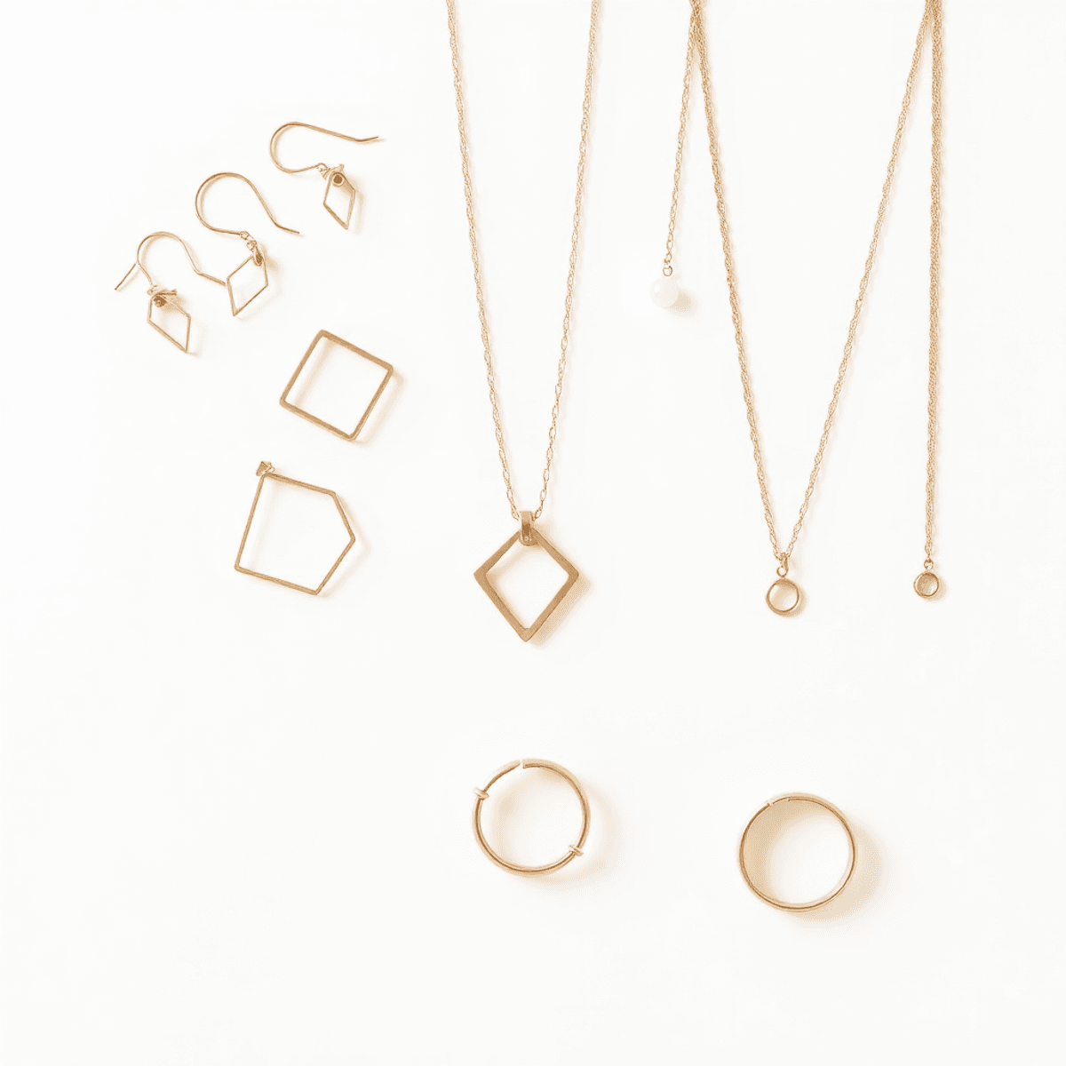 Elegant jewelry display with minimalist gold and rose gold earrings, necklaces, and rings on a neutral background, showcasing versatile day-to-night accessories